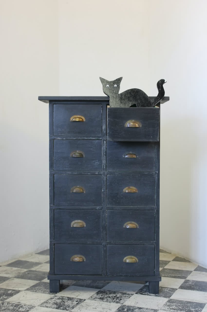 tall multi drawered chest with green interior